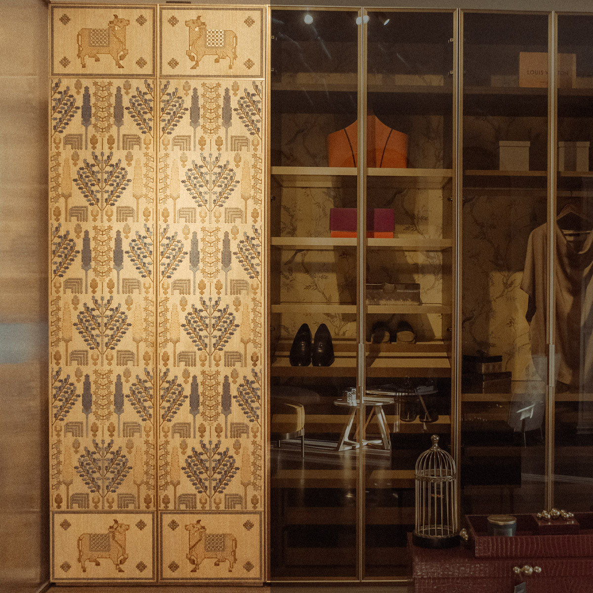 Embroidered White Oak veneer wardrobe shutters inspired by Persian carpet composition, stitched with cotton thread in blues and ochre tones.