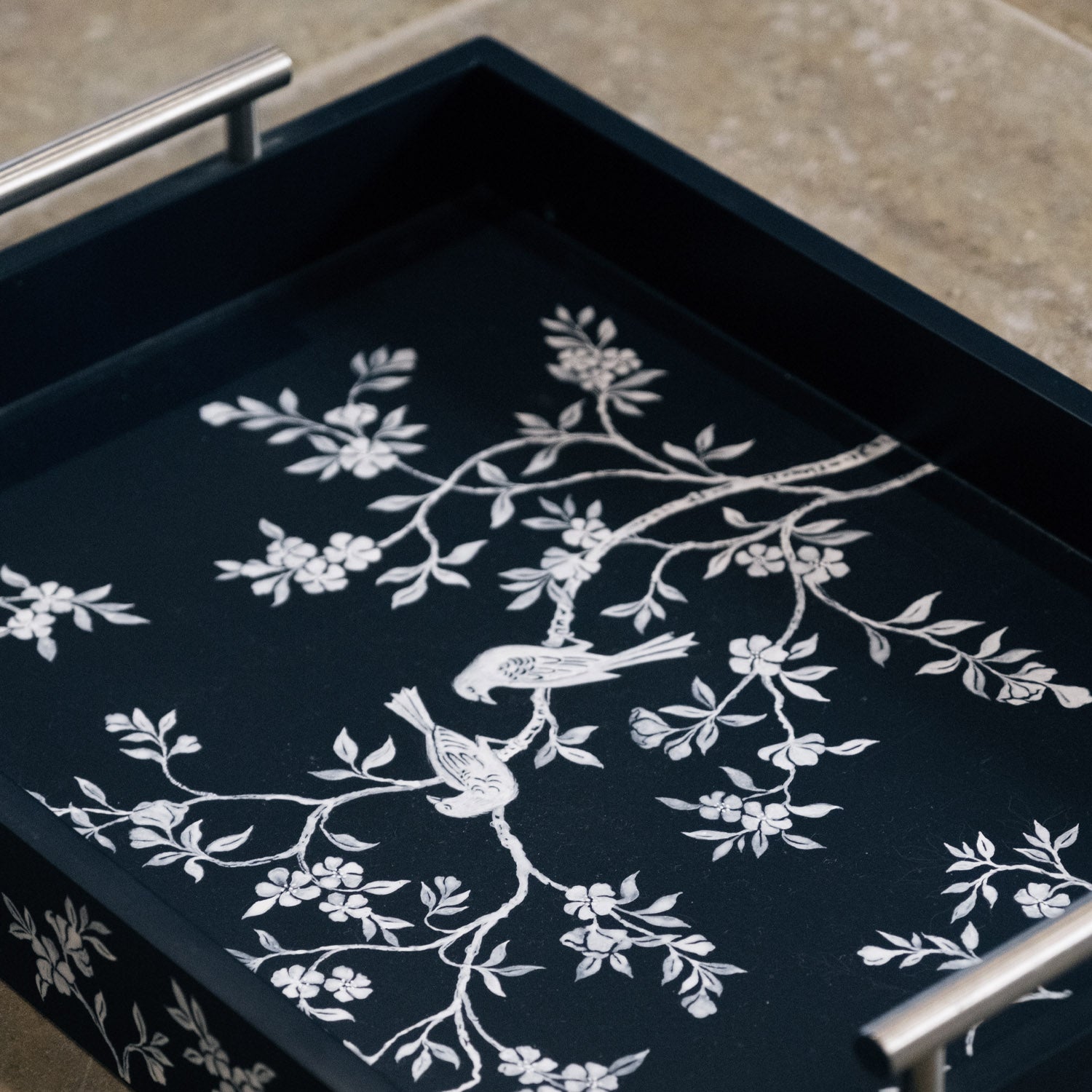 Hand painted chinoiserie tray featuring detailed botanical and ornamental motif