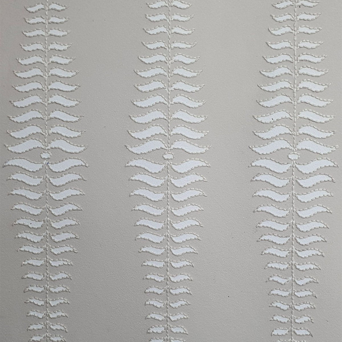 Prototype sample of embroidered fern wallpaper testing stitch density and paper compatibility.
