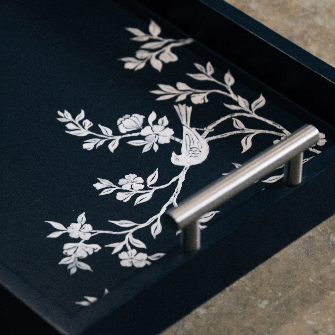 Angled view of embroidered textile tray demonstrating surface depth and edge finishing